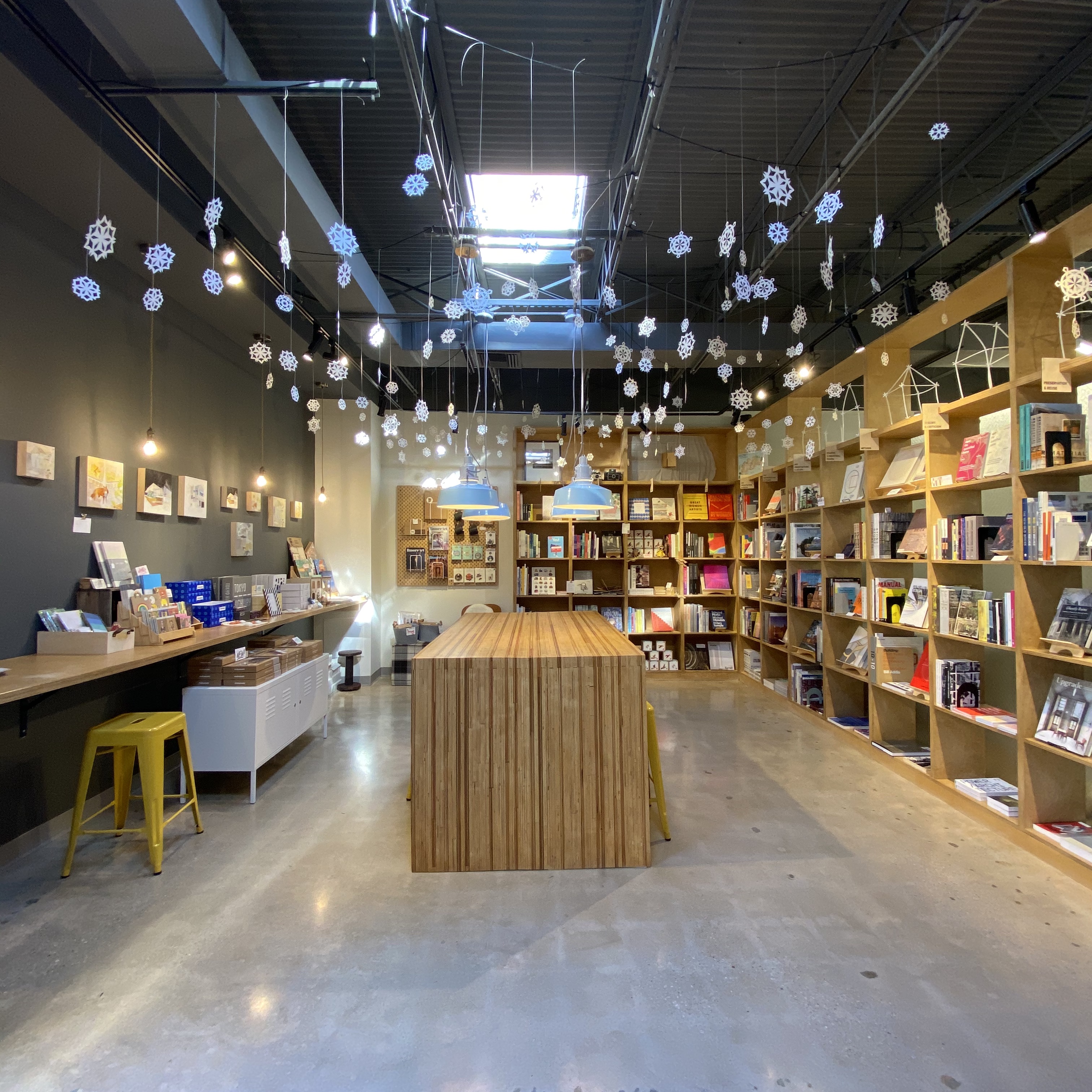 The interior of Co Lab featuring bookshelves, snowflake decorations, and art.