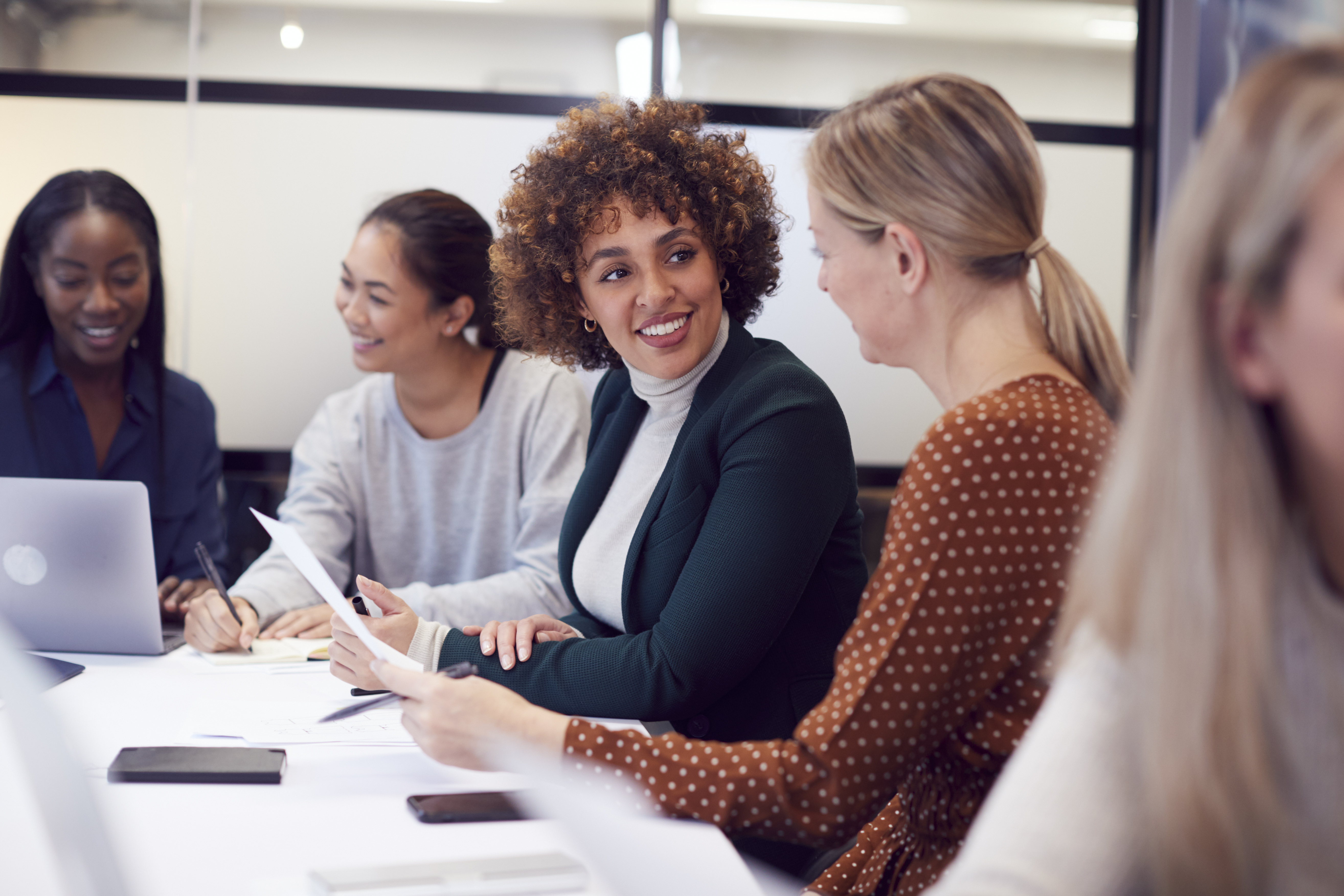 group of people talking around conference table