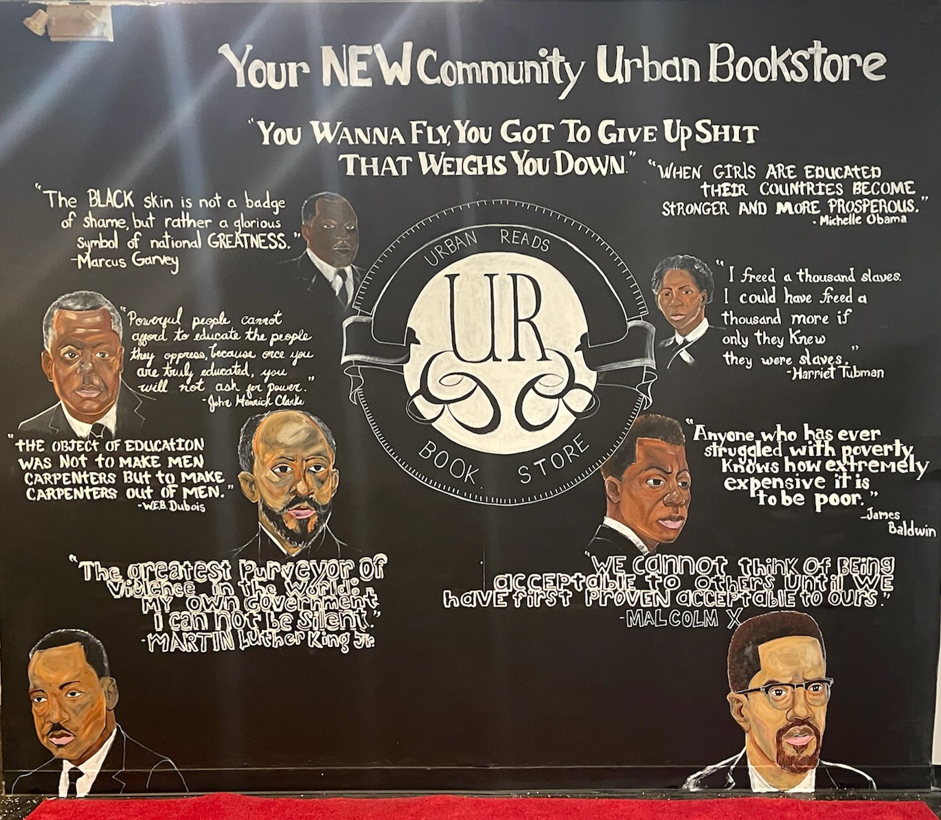 A mural inside Urban Reads Bookstore featuring portraits of and quotes from famous Black Americans throughout history.