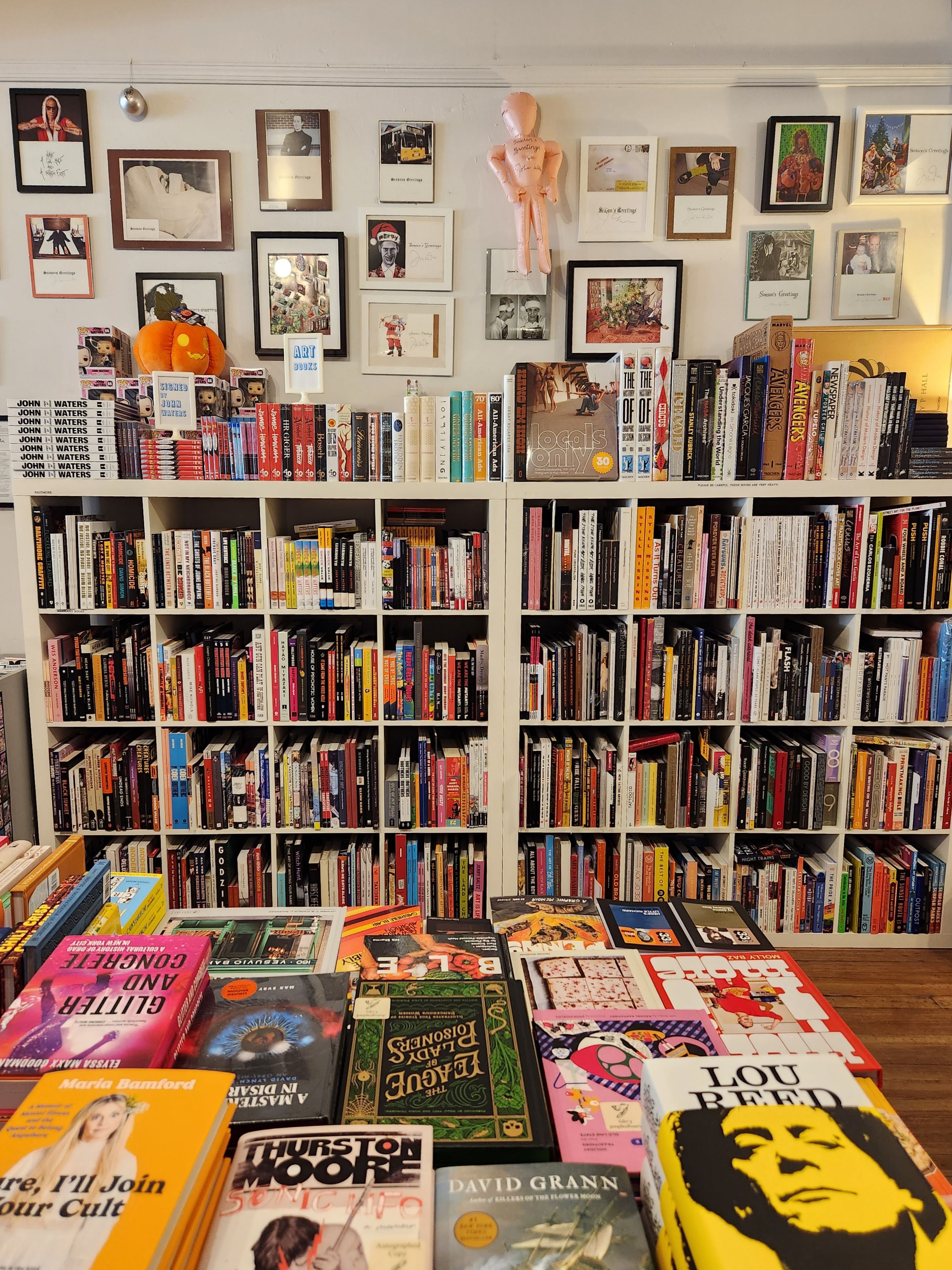 An interior wall inside Atomic Books featuring bookshelves and wall art