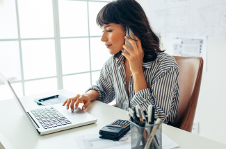 women on laptop and phone