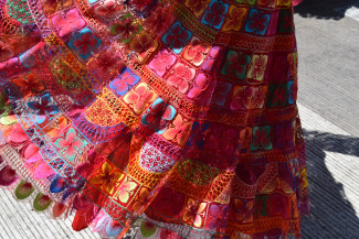 Close up bright, floral designed textile pattern of a skirt being worn during a dance in Atlixco Puebla