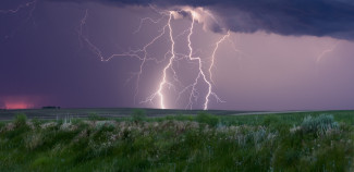 Rain storm with lighting over a field
